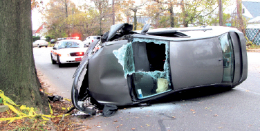Driver injured as sedan flips over Driver injured as sedan flips over