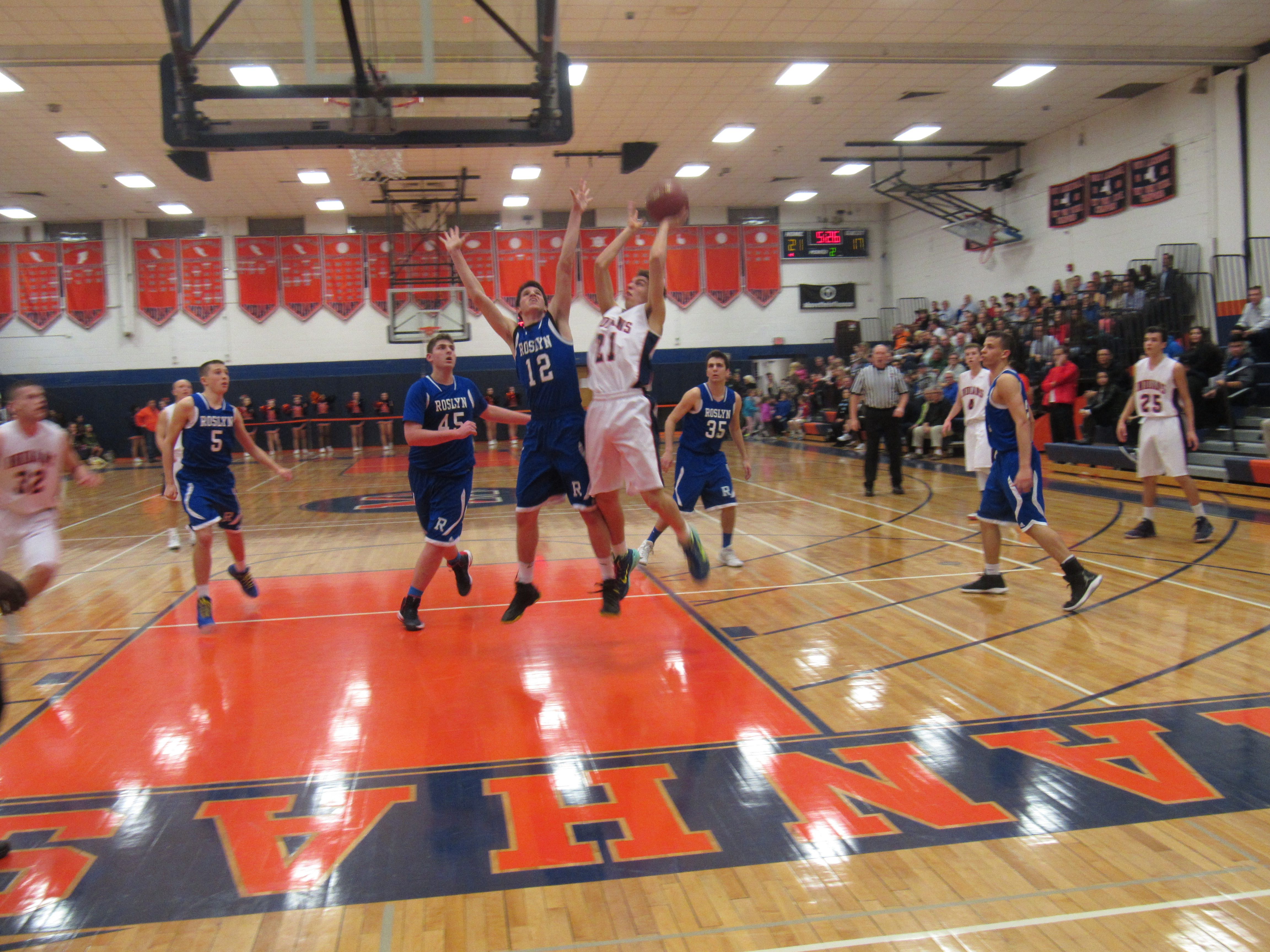  Manhasset sophomore guard Tom Santella and Roslyn junior guard Jacob Buchbinder (Photo by Gregory Giaconelli) 