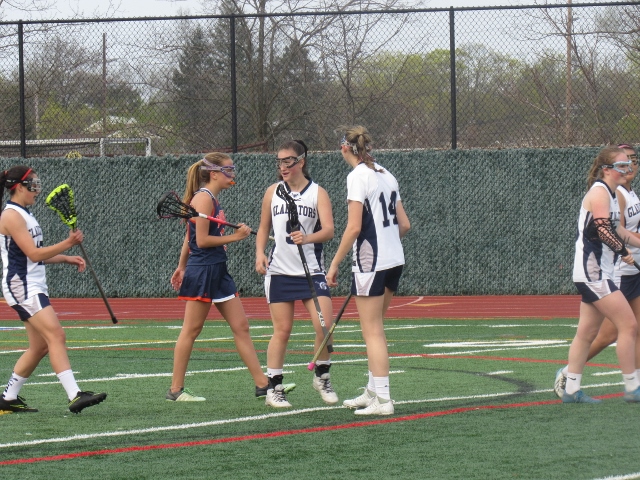 New Hyde Park congratulates attacker Geena Gardella (no. 9) on a goal (Photo by Gregory Giaconelli)