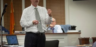 Joe Gill, village clerk-treasurer, explained the types of light fixtures and LED lights available at a previous meeting. (Photo by Janelle Clausen)