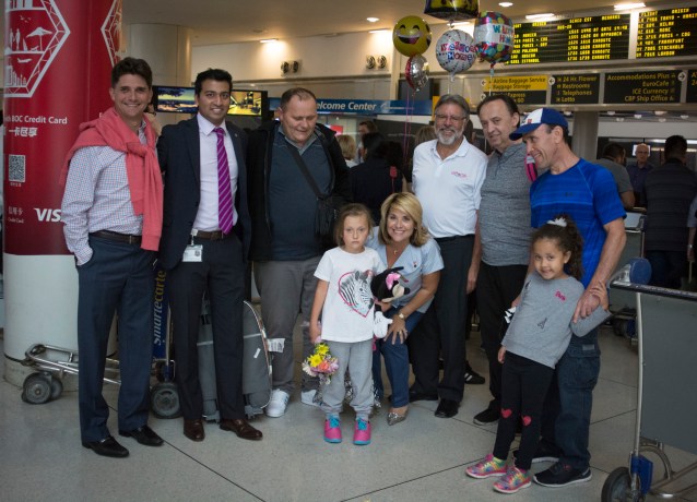 Roxana Gashi, 6, is flanked by Gift of Life volunteers who came to pick her up from the airport.