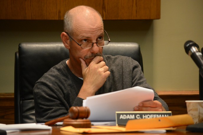 Village of Lake Success Mayor Adam Hoffman, as seen at a previous meeting, reviews slides from Extenet Systems, which hopes to boost cellphone coverage in the village. (Photo by Janelle Clausen)