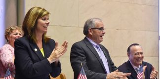 Assemblymembers Monica P. Wallace, Anthony D’Urso and Frank Skartados, along with Deborah Girgenti, Assemblyman D’Urso’s Albany Office Director, applaud the passage of the Cold War property tax exemption bill earlier this year. (Photo courtesy of Assemblyman Anthony D'Urso's office)