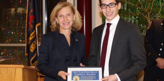 Senator Elaine Phillips presented the New York State Senate’s Liberty Medal to Oliver Rein, a 16-year-old Great Neck junior firefighter who extricated two people from a vehicle after the car crashed into a tree in August. (Photo courtesy of state Sen. Elaine Phillips' office)