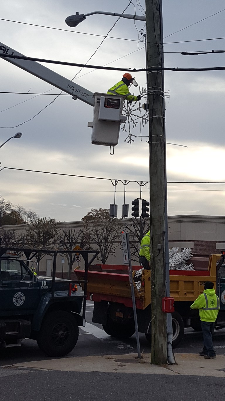 Snowflakes are installed around Port Washington
