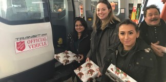 Employees Alice Joseph, Patricia Reilly and Valentina Faraci hand off presents to the Salvation Army from Transervice Long Island’s corporate headquarters in Lake Success. (Photo courtesy of Transervice Logistics)