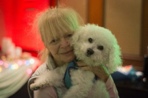 Lanie, 70, came to the party with her 12-year-old "pup" Kenny. "He loves children," Lanie said. "He loves everyone." (Photo by Janelle Clausen)