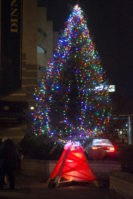 This Christmas tree was lit up with the help of Lily, 4, a pre-K Parkwood student who came with her mom. She said liked green and all the other colors. (Photo by Janelle Clausen) 