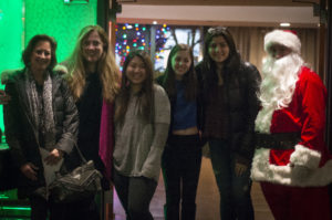 Members of the South High School Choir pose with Mayor Jean Celender, Janine Robinson and Santa Claus. (Photo by Janelle Clausen)