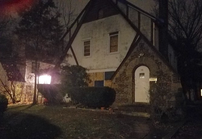 36 Brokaw Lane was left scorched and boarded up following a fire that ousted at least 13 people from the home. (Photo by Janelle Clausen)