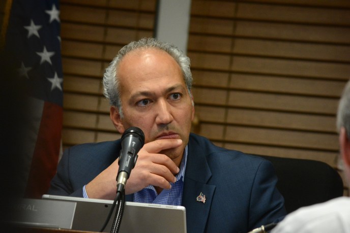 Great Neck Village Mayor Pedram Bral listens as residents speak at a board meeting. (Photo by Janelle Clausen)