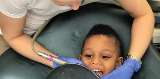 Anna Kwasnik, a dentist with Passes Dental Care in Great Neck, works on cleaning a child's mouth. (Photo courtesy of Passes Dental Care)