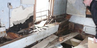 A county architect inspects the Saddle Rock Grist Mill's interior on Feb. 21, 2018. (Photo courtesy of the Great Neck Historical Society)