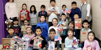 Ms. Ellen Siegel joins Ms. Jillian Brock and her third-grade students with their suitcases. (Photo courtesy of the Great Neck Public Schools)