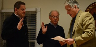 Russell Gardens Mayor Steve Kirschner, right, swears Trustees Matthew Ellis and David Miller into another term. (Photo by Janelle Clausen)