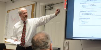 Village Clerk-Treasurer Joe Gill discusses the $9.67 million budget at a Tuesday night board meeting. (Photo by Janelle Clausen)