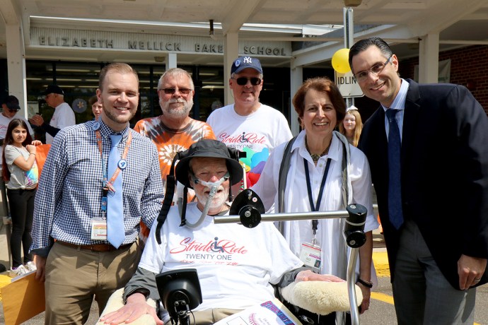 Ride for Life founder Christopher Pendergast is joined by teacher Christopher Lynch, Ride participants Paul Weisman and Nelson Colon, Principal Sharon Fougner, and Michael Grimaldi at the E.M. Baker School. (Photo courtesy of the Great Neck Public Schools)