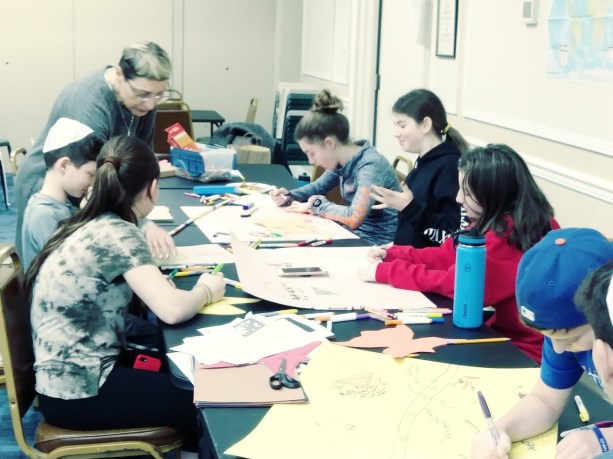 Students at the Lake Success Jewish Center are guided through an art project. (Photo courtesy of the Lake Success Jewish Center Hebrew School)