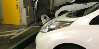 The village's 2017 Nissan Leaf, an electric car, sits parked at a public charging station in a garage. (Photo courtesy of Great Neck Plaza)