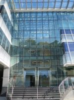 An up close view of the nearly complete building shows a glass atrium, floor-to-ceiling windows and other features. (Photo courtesy of JLL)