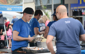 Vendors prepare food for a carnival patron. (Photo by Janelle Clausen)