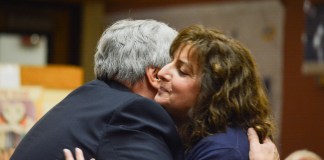 South Middle School Principal James Welsch embraces Carla Diesu, who was later approved for tenure. (Photo by Janelle Clausen)