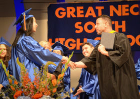 Kimberly Lu, the valedictorian for Great Neck South High's class of 2018, collects her diploma as her colleagues cheer. (Photo by Janelle Clausen)