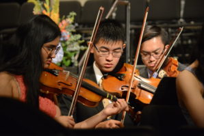 A trio of students in the Great Neck North Symphony Orchestra practice before commencement begins. (Photo by Janelle Clausen)