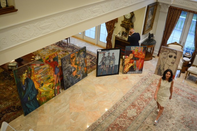 Edna Mashaal, the head of Edna Mashaal Realty, looks up to the balcony as she peruses Marc Ferrero's work. (Photo by Janelle Clausen)