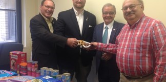 Long Island Cares Chief Executive Officer Paule T. Pachter, Long Island Cares Manager of Community Events and Food Drives William Gonyou, Assemblyman Anthony D’Urso, and Donald Panetta from Temple Tikvah Brotherhood pose for a photo with some of the donations. (Photo courtesy of Assemblyman Anthony D'Urso's office)