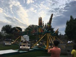 Carnival goers whirl around in the Scrambler at the Village Green on Saturday night. (Photo by Chris Eder)