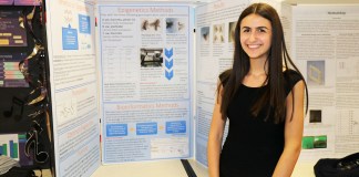 North High senior Jacqueline Slobin with her research on the genetic eye color of flies, which she conducted at St. John’s University last summer. (Photo courtesy of the Great Neck Public Schools)