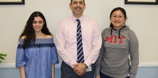 North High Principal Daniel Holtzman congratulates Courtney Hakimian and Megan Xu on being National Merit Scholars. (Photo courtesy of the Great Neck Public Schools)