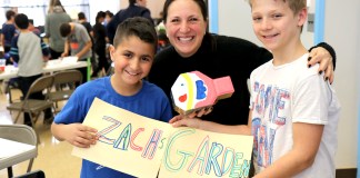 Robin Portnoy is greeted by Saddle Rock students during an activity for the garden renovation project. (Photo courtesy of the Great Neck Public Schools)