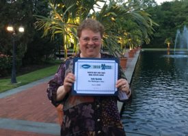 Judy Epstein holds up her award for excellence in humor column writing. (Photo courtesy of Judy Epstein)