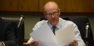 Mayor Adam Hoffman reviews a set of documents during Monday night's board meeting. (Photo by Janelle Clausen)