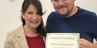 Great Neck Library Director Denise Corcoran presents a Staff Excellence Award to Nicholas Pontolillo. (Photo courtesy of the Great Neck Library)