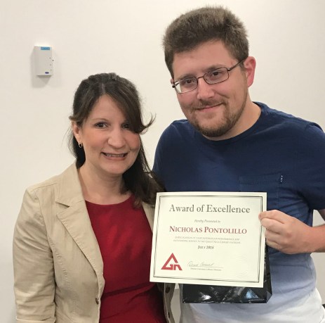 Great Neck Library Director Denise Corcoran presents a Staff Excellence Award to Nicholas Pontolillo. (Photo courtesy of the Great Neck Library)