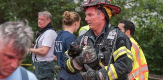 A firefighter from Vigilant Fire Company holds one of survivors from the house fire. (Photo courtesy of Over the Edge Photography)