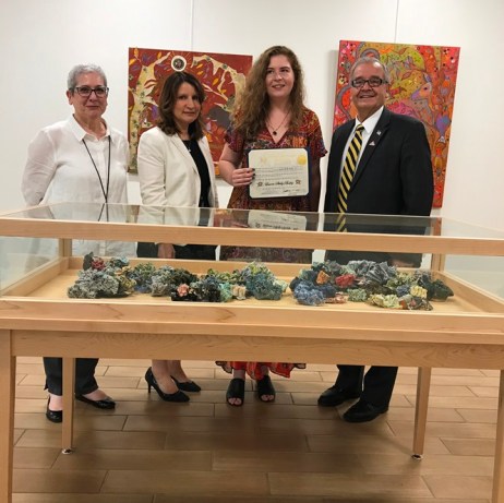Artist Lauren Skelly Bailey, joined by Great Neck Library Art Committee Chair Pamela Levin, Great Neck Library Director Denise Corcoran and Assemblyman Anthony D'Urso, holds her citation. (Photo courtesy of Assemblyman Anthony D'Urso's office)