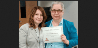 Great Neck Library Director Denise Corcoran presents a Staff Excellence Award to Jennifer Ransom. (Photo courtesy of the Great Neck Library)