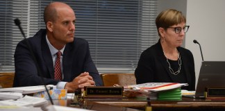 Superintendent of Schools Vincent Butera and Board President Regina Rule listen as students and parents speak. (Photo by Janelle Clausen)