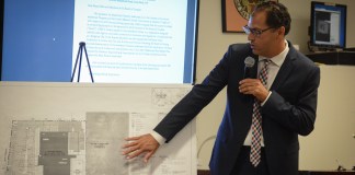 Michael De Giglio, an associate with Cameron Engineering, reviews the early site plan for a proposed Mashadi Jewish Community Center. (Photo by Janelle Clausen)