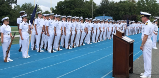 U.S. Navy Capt. Steven Urwiller speaks to the U.S. Merchant Marine Academy Class of 2022 prior to swearing them in as Midshipmen in the U.S. Navy Reserve. Urwiller spoke at the Academy’s Toom Field during Parents Weekend. (Photo courtesy of the U.S. Merchant Marine Academy)