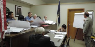 Architect Ronald Zakary reviews the revised building plans for Tower Ford with Thomaston Mayor Steve Weinberg, center left, and the board. (Photo by Samuel Glasser)