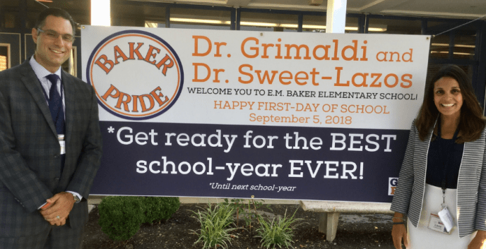 Michael Grimaldi and Heather Sweet-Lazos, the principal and assistant principal of E.M. Baker Elementary School, welcome back students. (Photo courtesy of the Great Neck Public Schools)