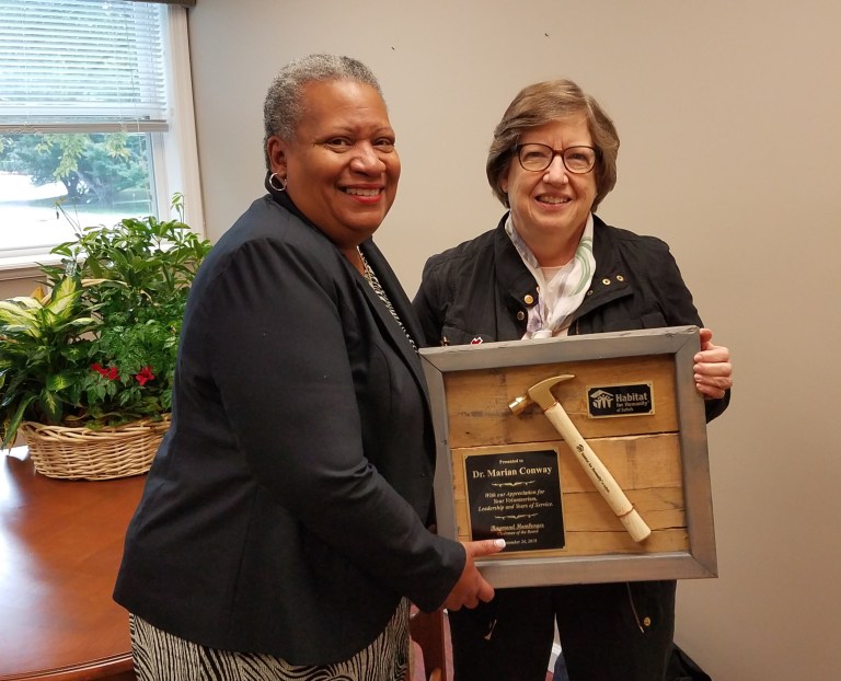 Habitat Suffolk’s executive director honors key board member
