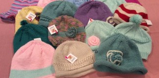 Hats knit by volunteers bring comfort and warmth to persons in need. (Photo by Desiree Shar)