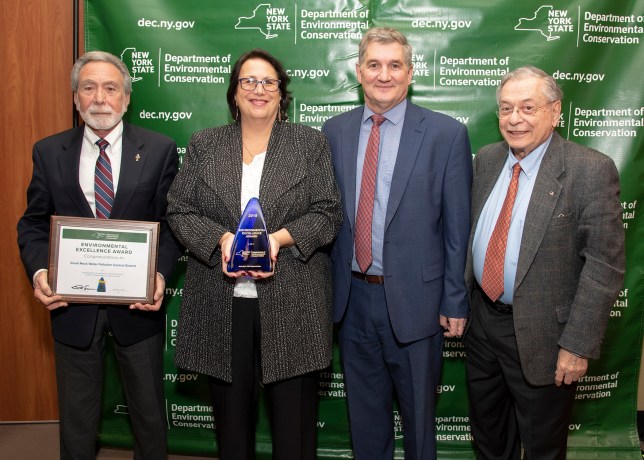Great Neck Water Pollution Control District Commissioner Steve Reiter, GNWPCD Commissioner Patty Katz, New York State DEC Executive Deputy Commissioner Kenneth Lynch and GNWPCD Commissioner Jerry Landsberg pose together during the NYS DEC Environmental Excellence Award ceremony and reception. (Photo courtesy of the Great Neck Water Pollution Control District)