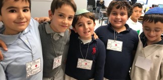 Silverstein Hebrew Academy second graders with their medical badges after they performed their contraction surgeries. (Photo courtesy of Silverstein Hebrew Academy)